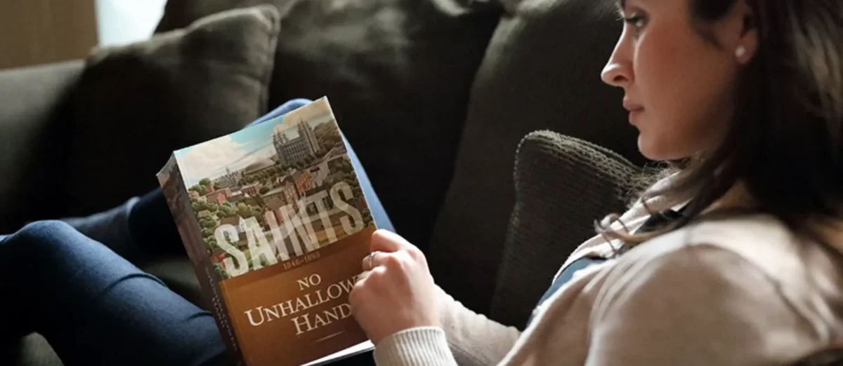 Woman Holding a Copy of Saints